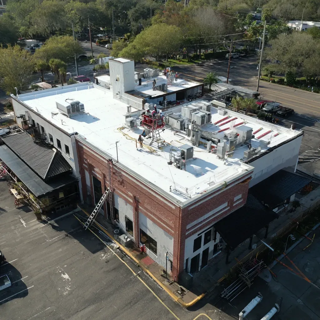 Shopping plaza rooflines in Brandon Florida showing TPO membrane overlays and rooftop ductwork visible from aerial perspective.
