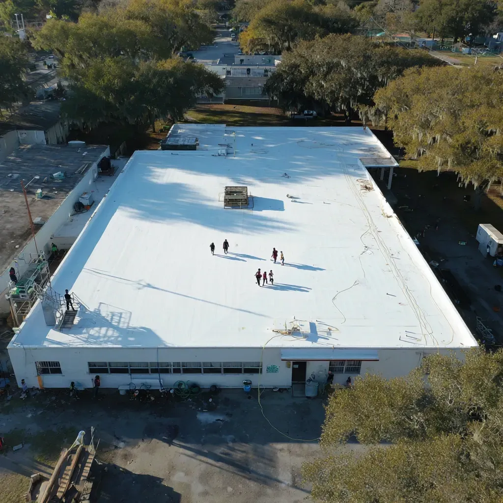 Aerial drone view of Brandon FL business parks featuring white reflective flat roofing systems and HVAC-heavy layouts.