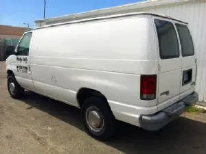 White cargo van parked outdoors.