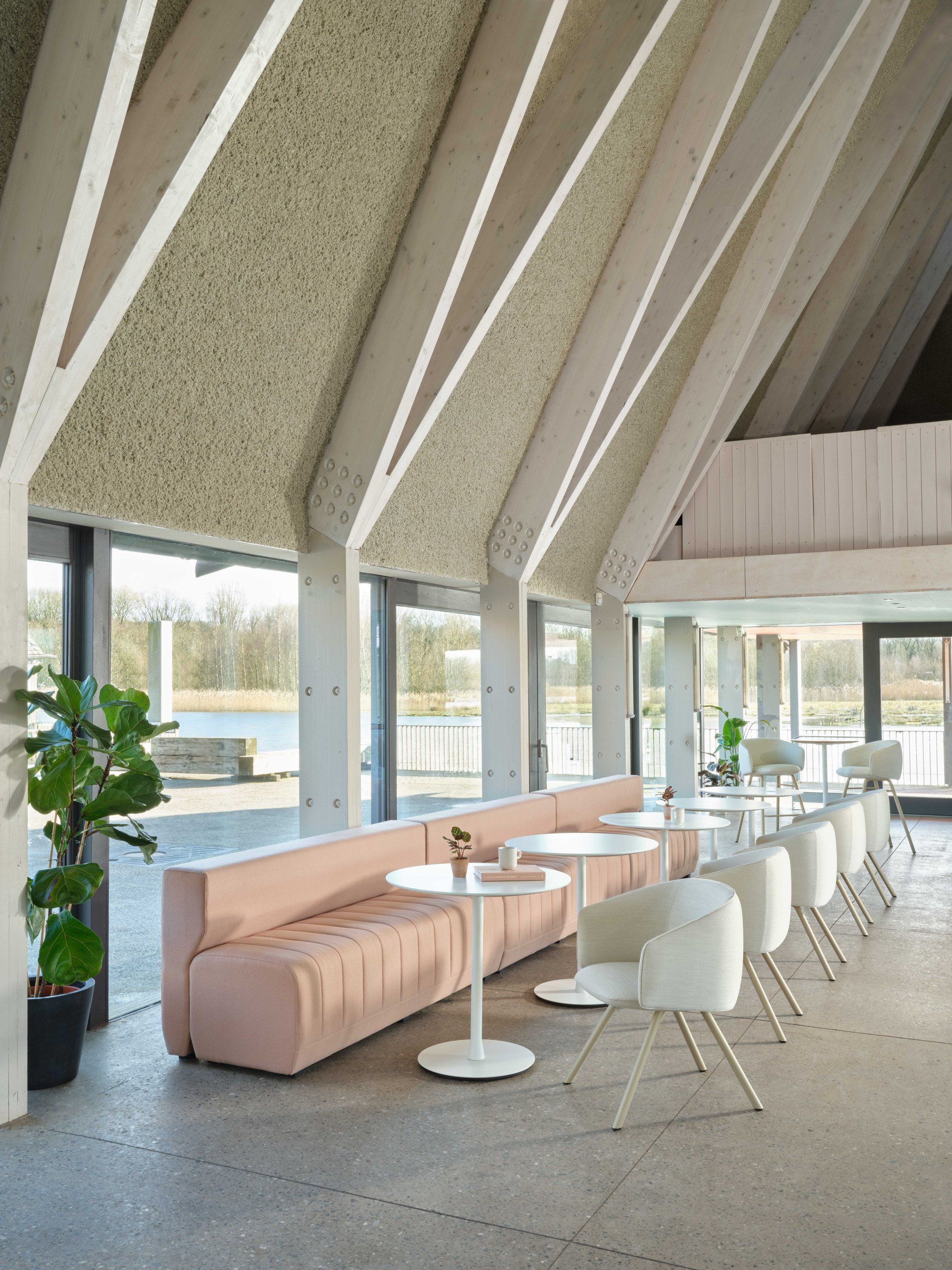 a large room with tables and chairs and a large window