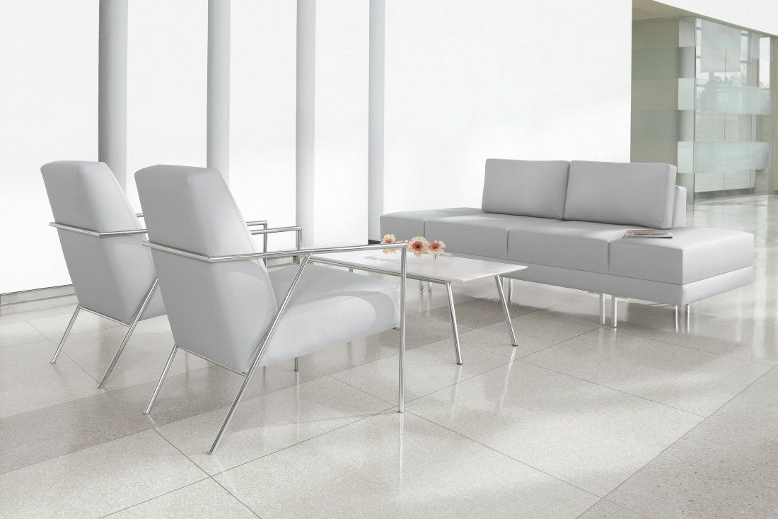 a waiting room with white chairs and a couch