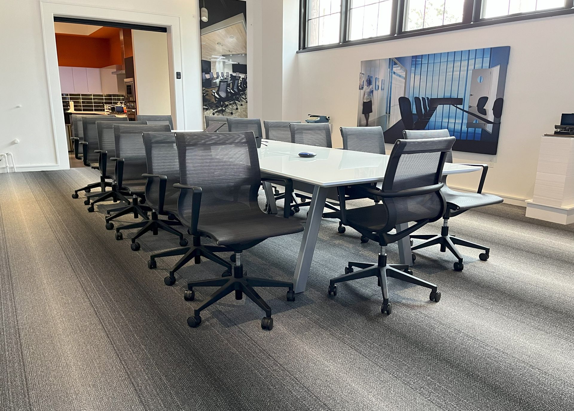 A conference room with a long table and chairs.