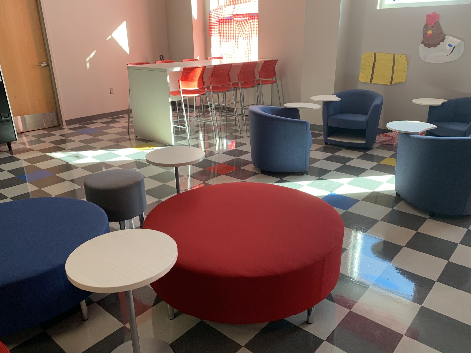 Multipurpose lounge seating groups in a room with checkered floor.