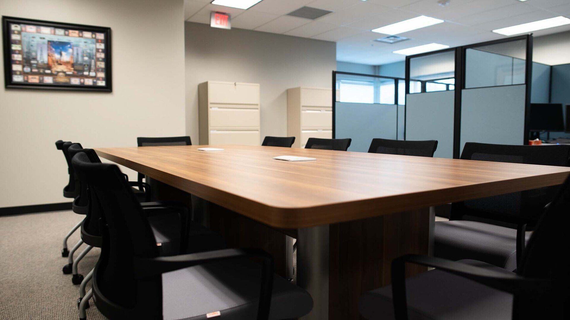 a conference room with a large wooden table and chairs