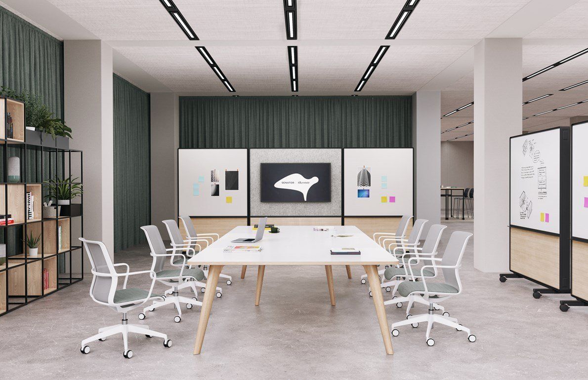 a conference room with a large white table and chairs