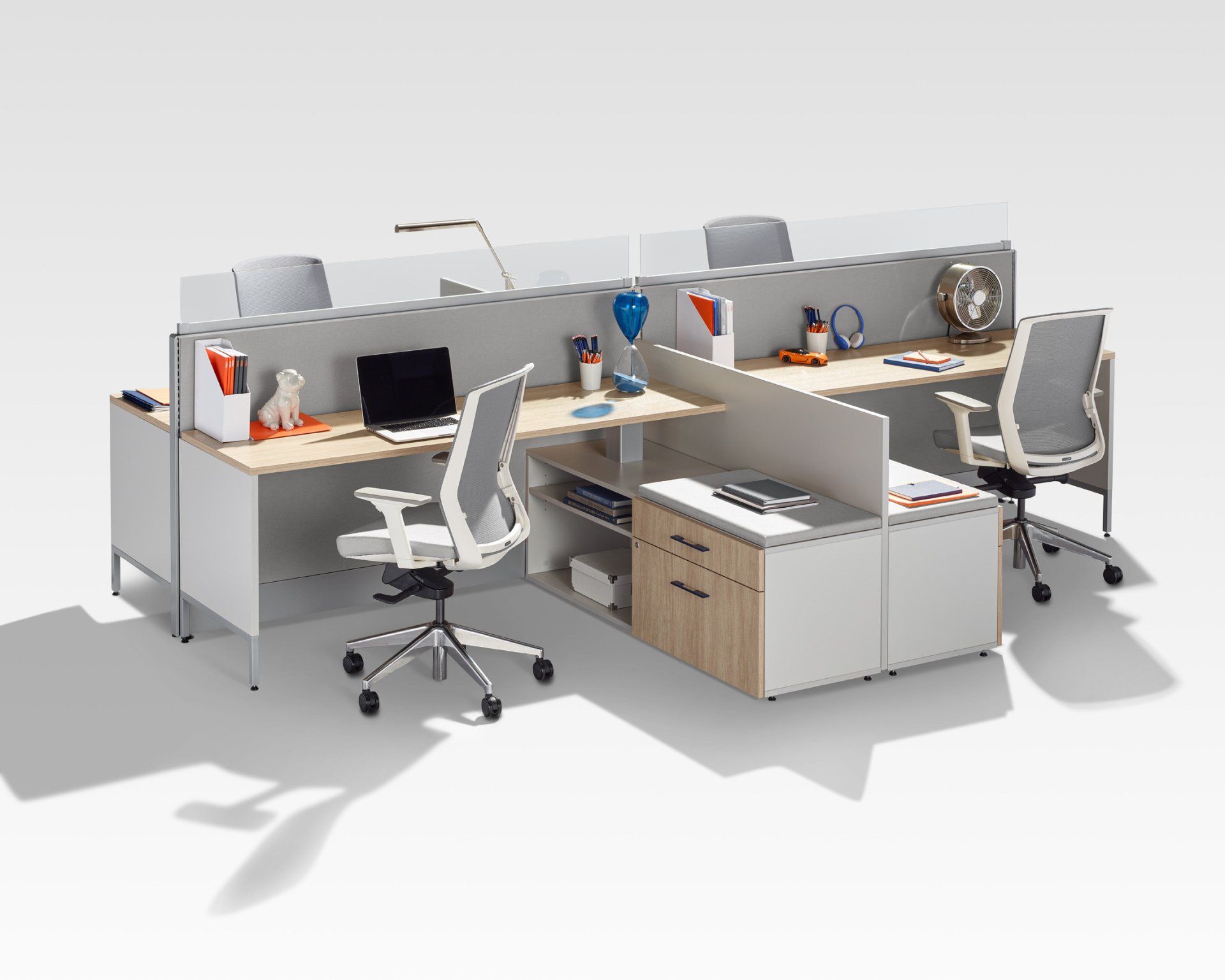 Overhead view of a modern office workstation with several white desks, black chairs, and colorful storage.