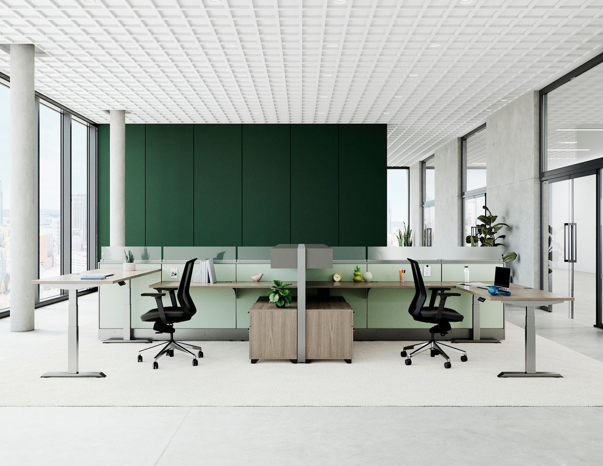 Modern office space with desks, chairs, and green accent wall. Large windows, white ceiling, and light wood cabinets.