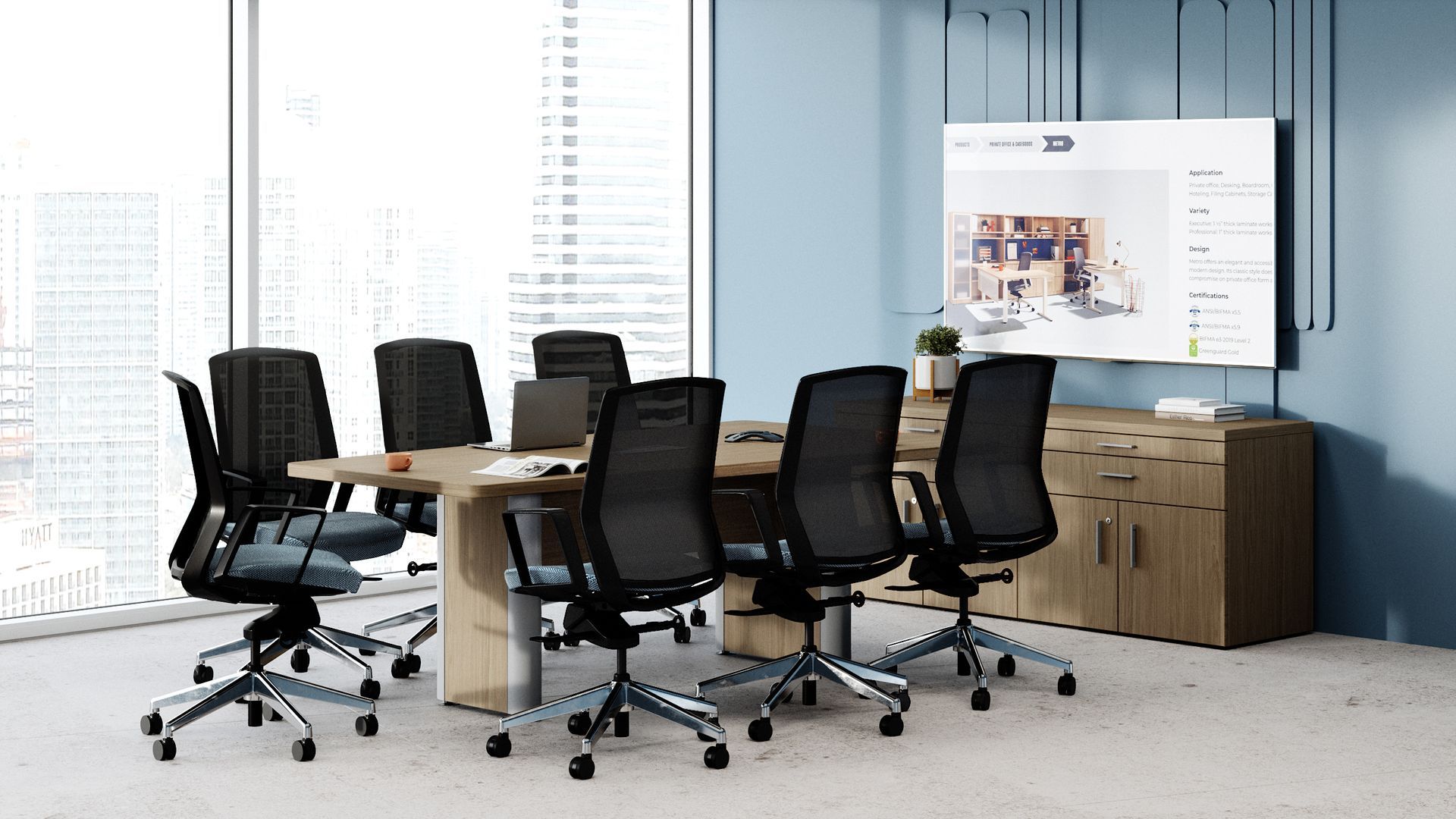 A conference room with a table and chairs and a large screen on the wall.