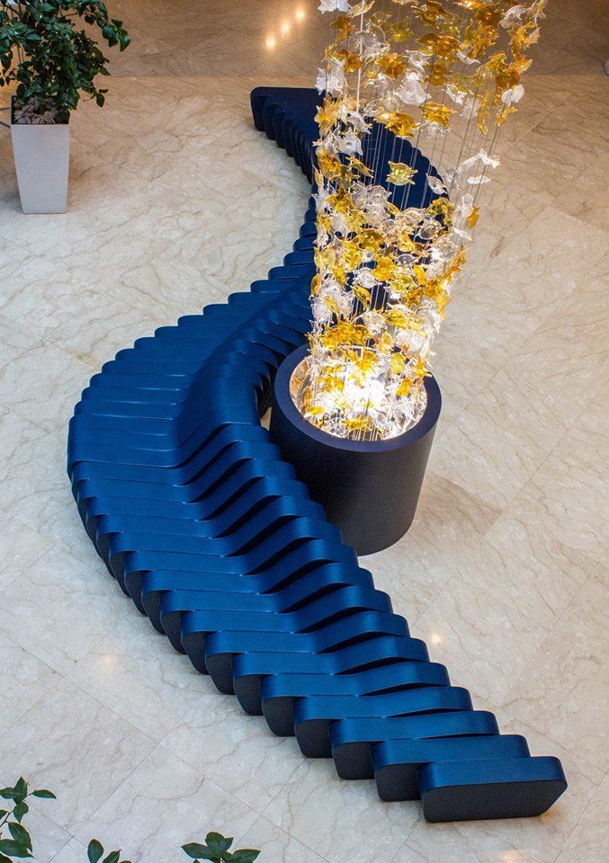 Large blue Cliffy modular sofa next to a glass sculpture.