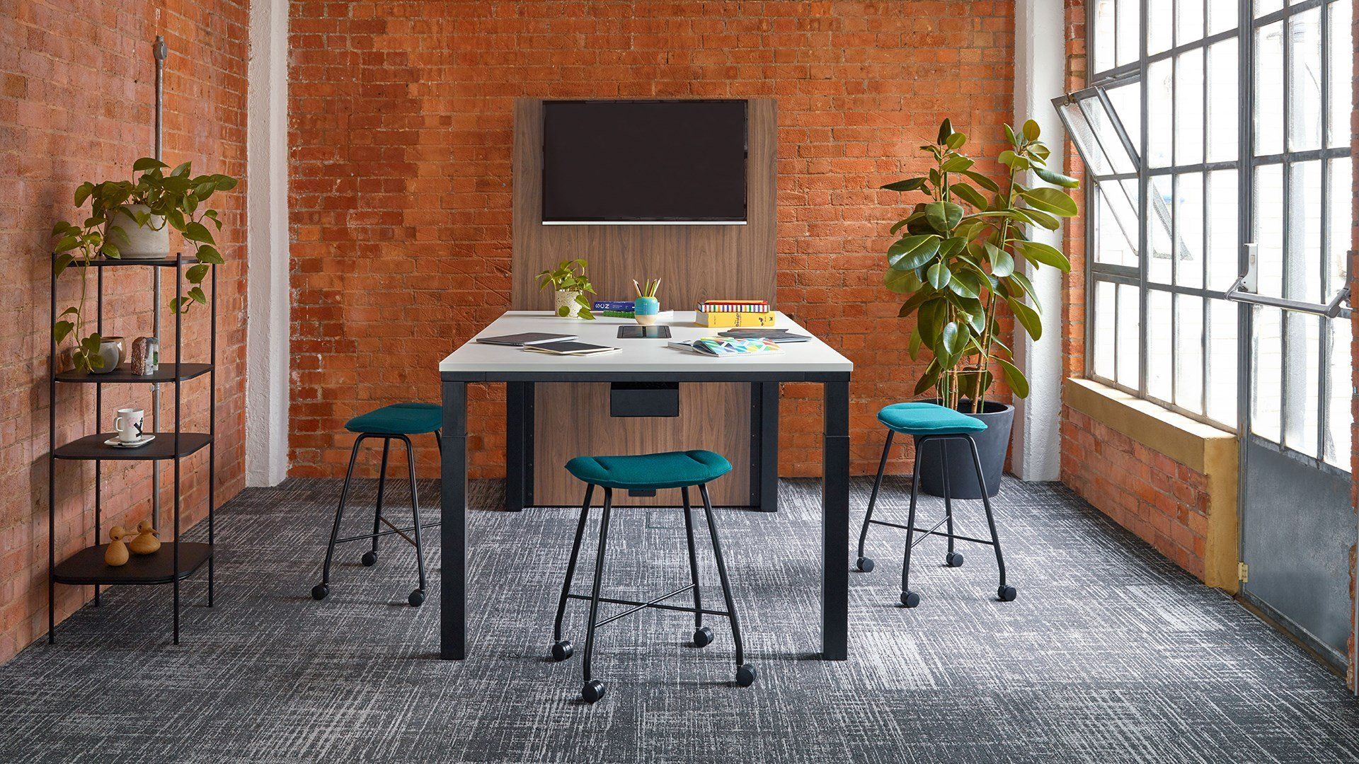 a room with a table and stools and a brick wall