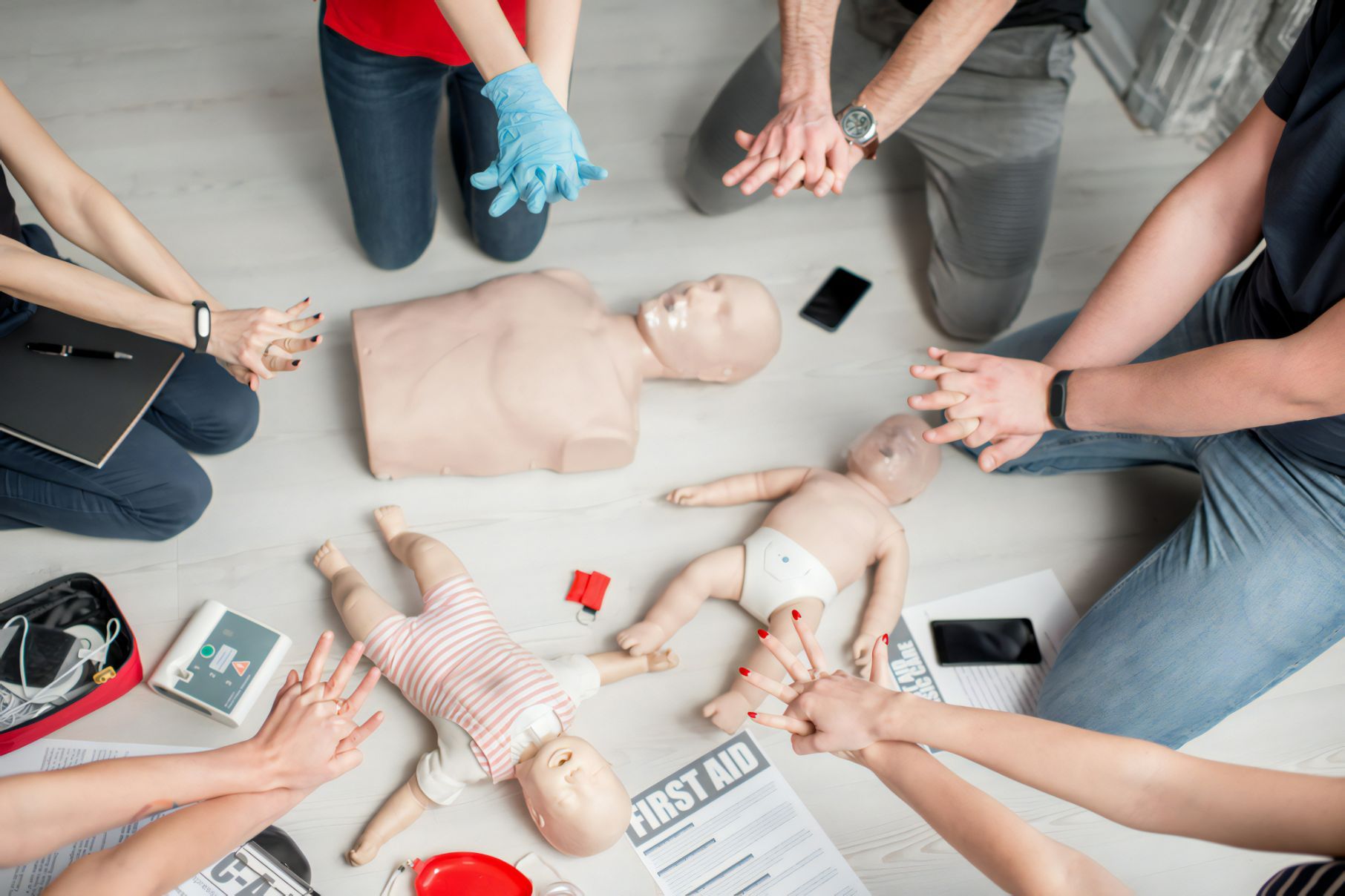 Group Of People Learning How To Make First Aid Heart Compressions With Dummies — Revive Training in Casino, NSW