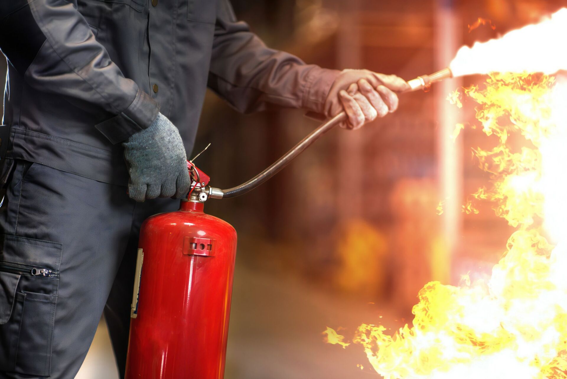 Man Using Fire Extinguisher Fighting Fire — Revive Training in Alstonville, NSW
