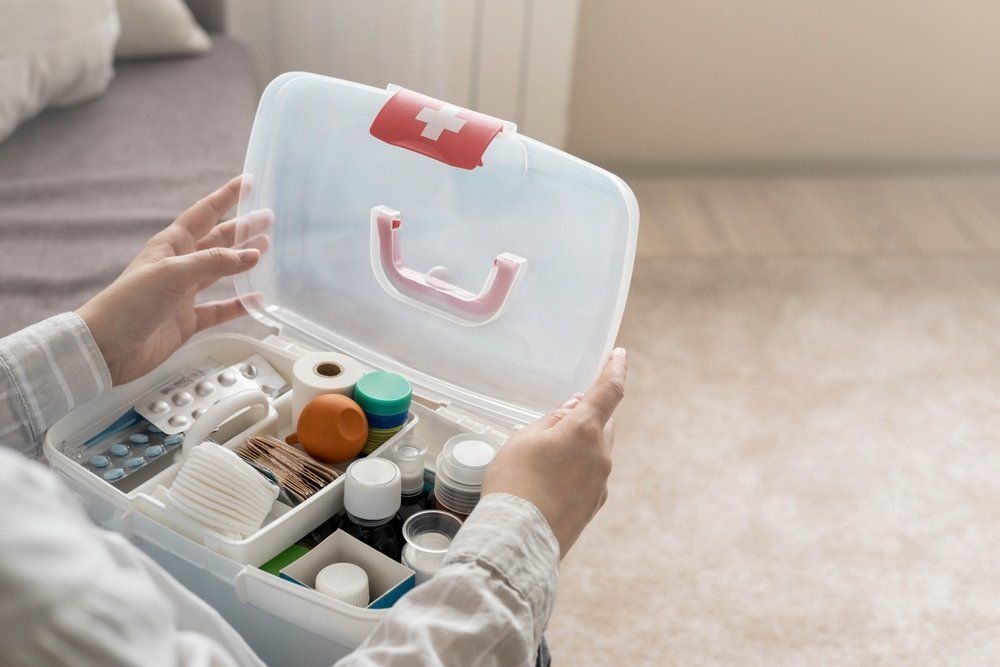 A Person Checking The First Aid Kit — Revive Training in Alstonville, NSW