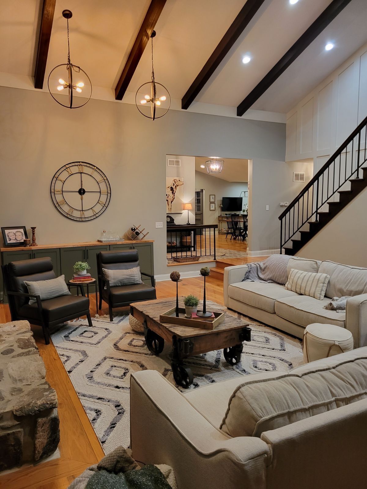 A living room filled with furniture and a clock on the wall.
