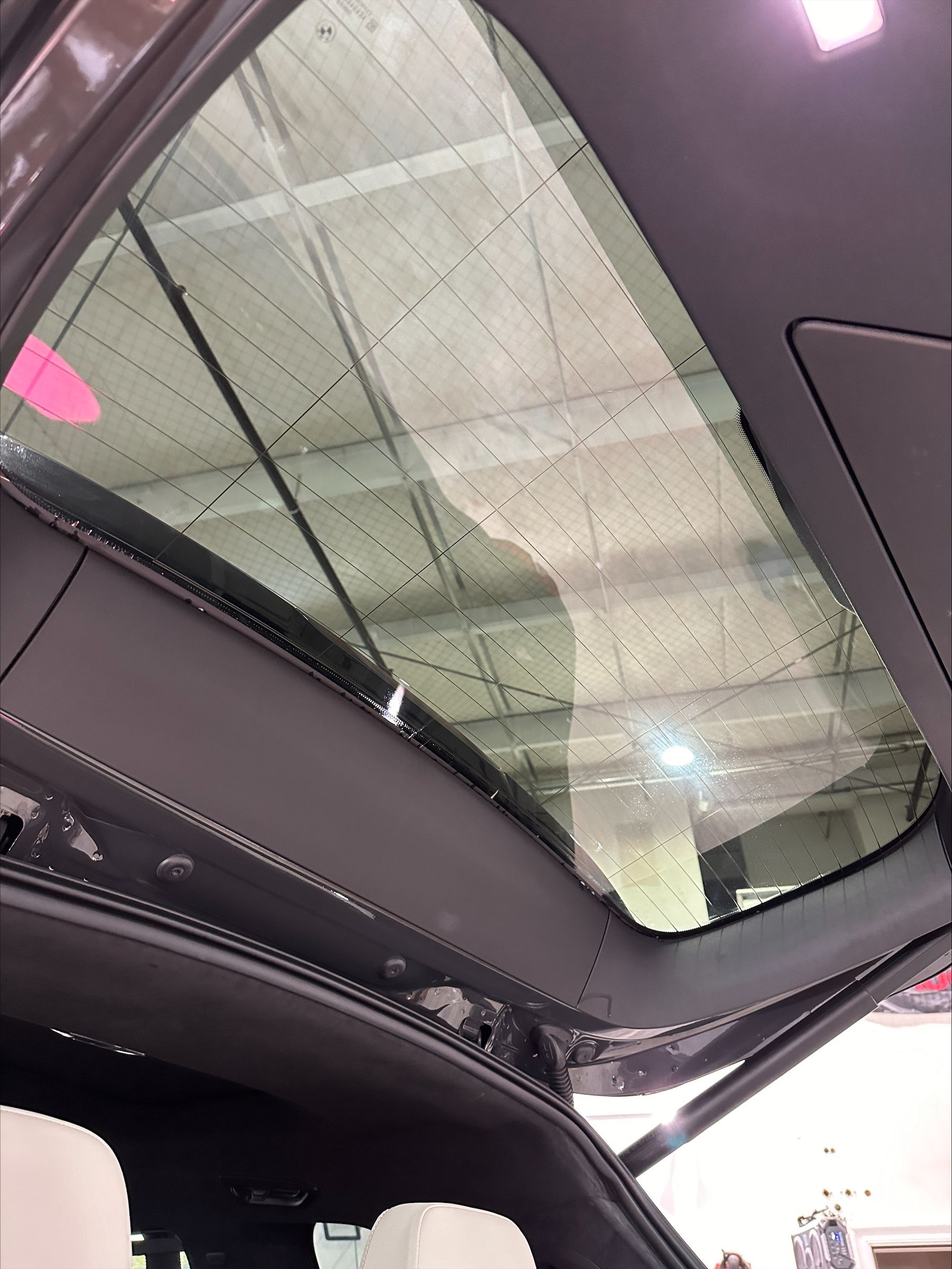 The back of a car with the sunroof open