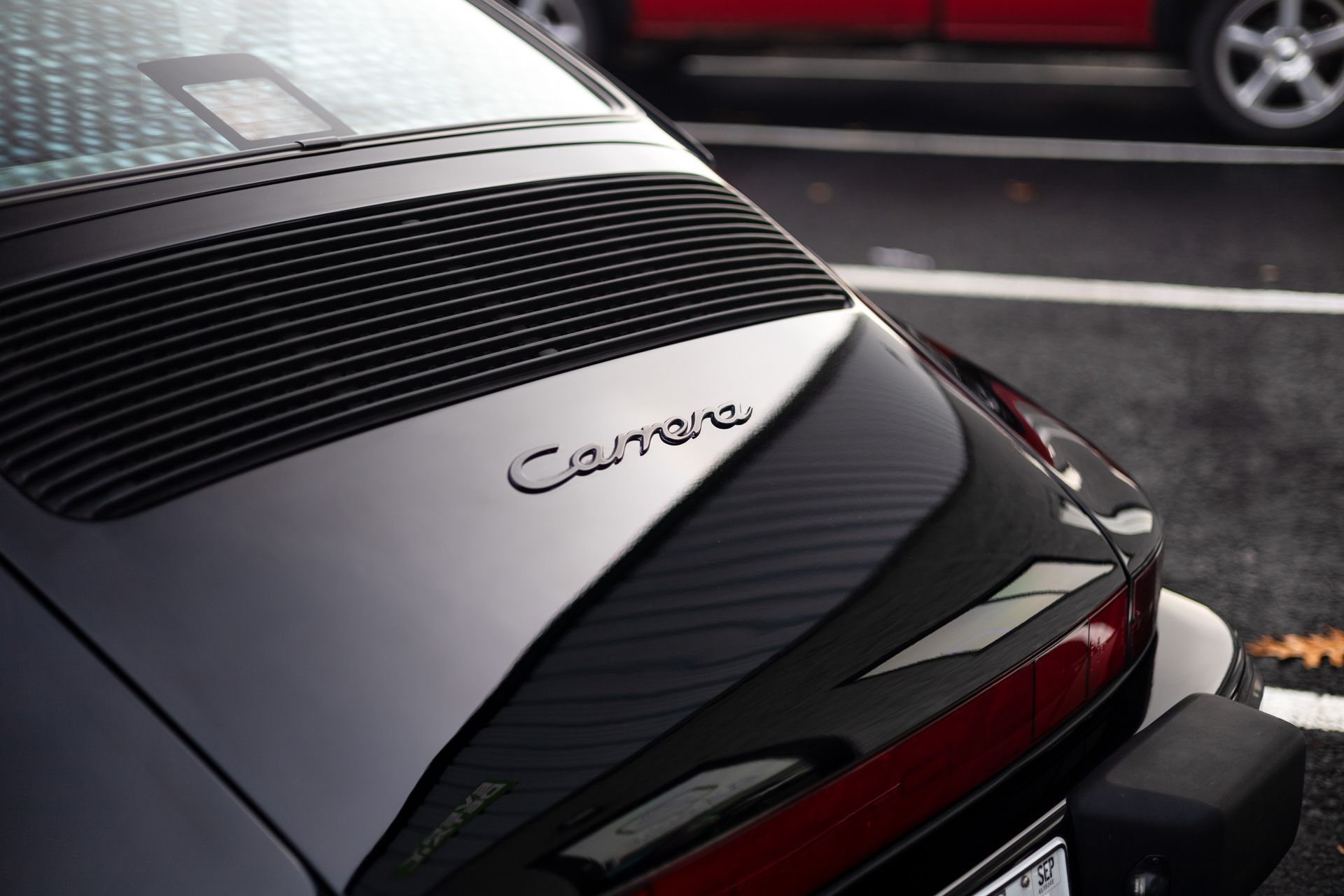 Black Porsche Carrera rear with black grill and silver lettering.