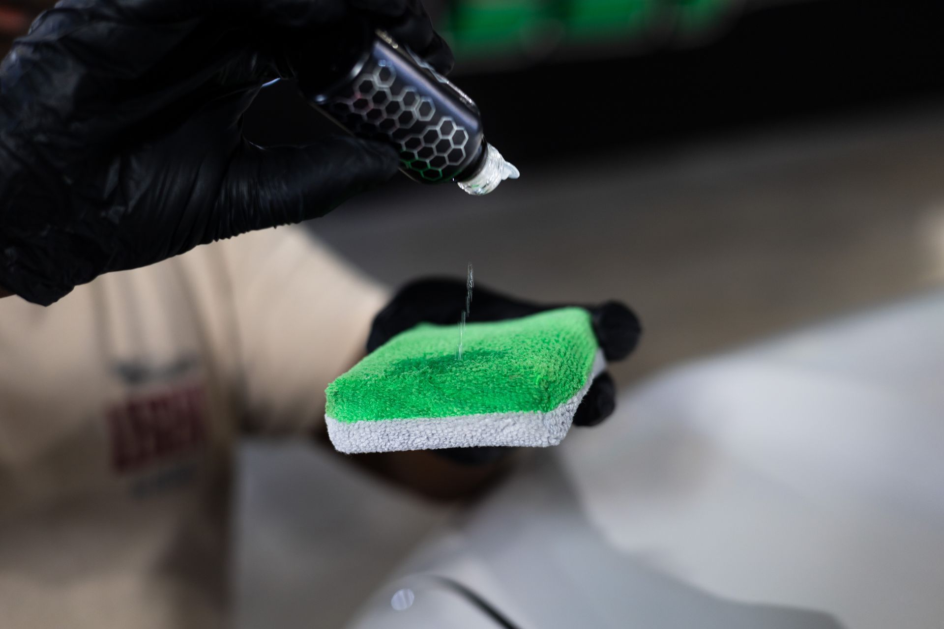 A white tesla model 3 is parked in front of a building