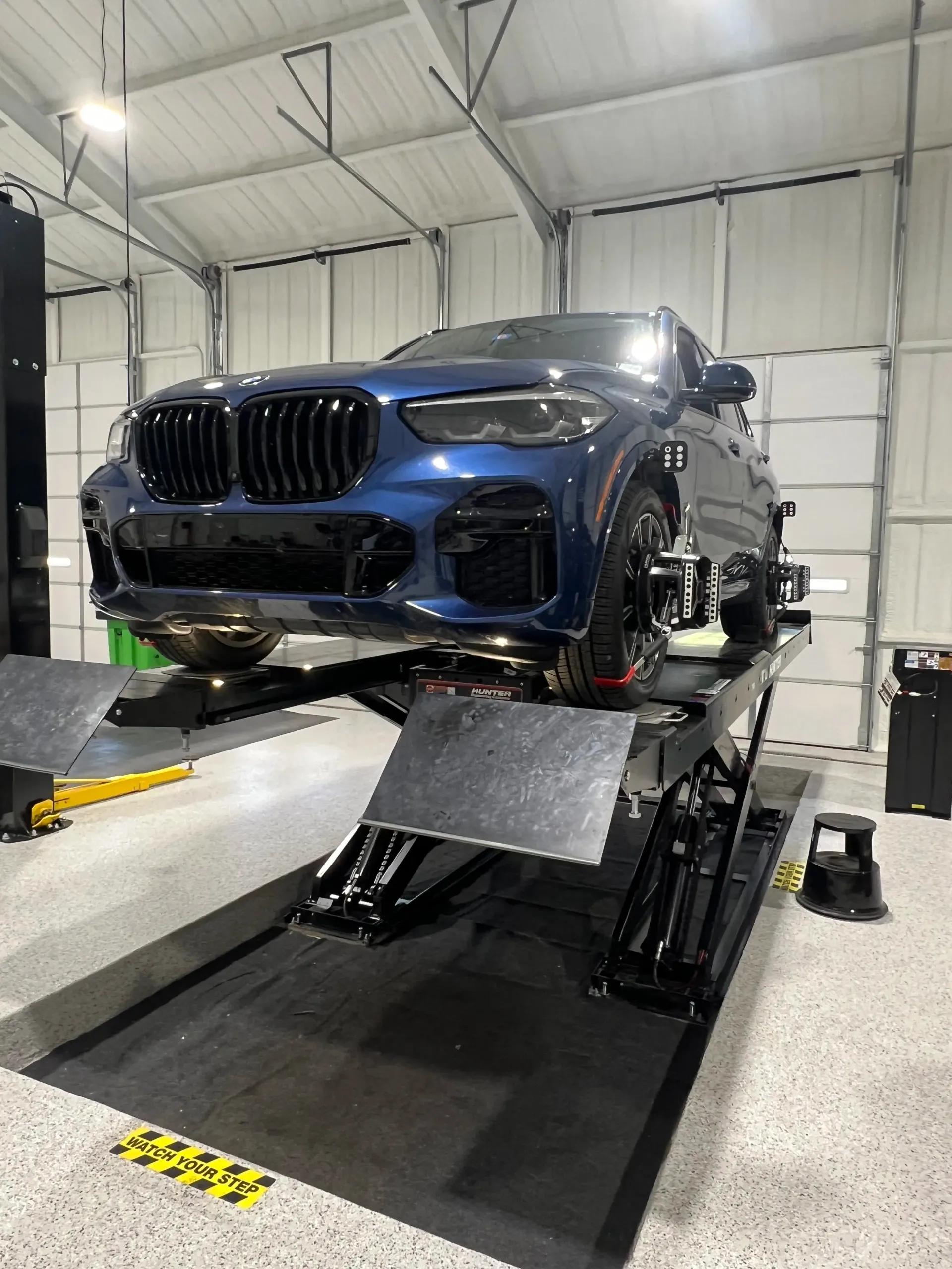 Blue SUV on a Hydraulic Lift in a Garage | Dillon Auto Repair