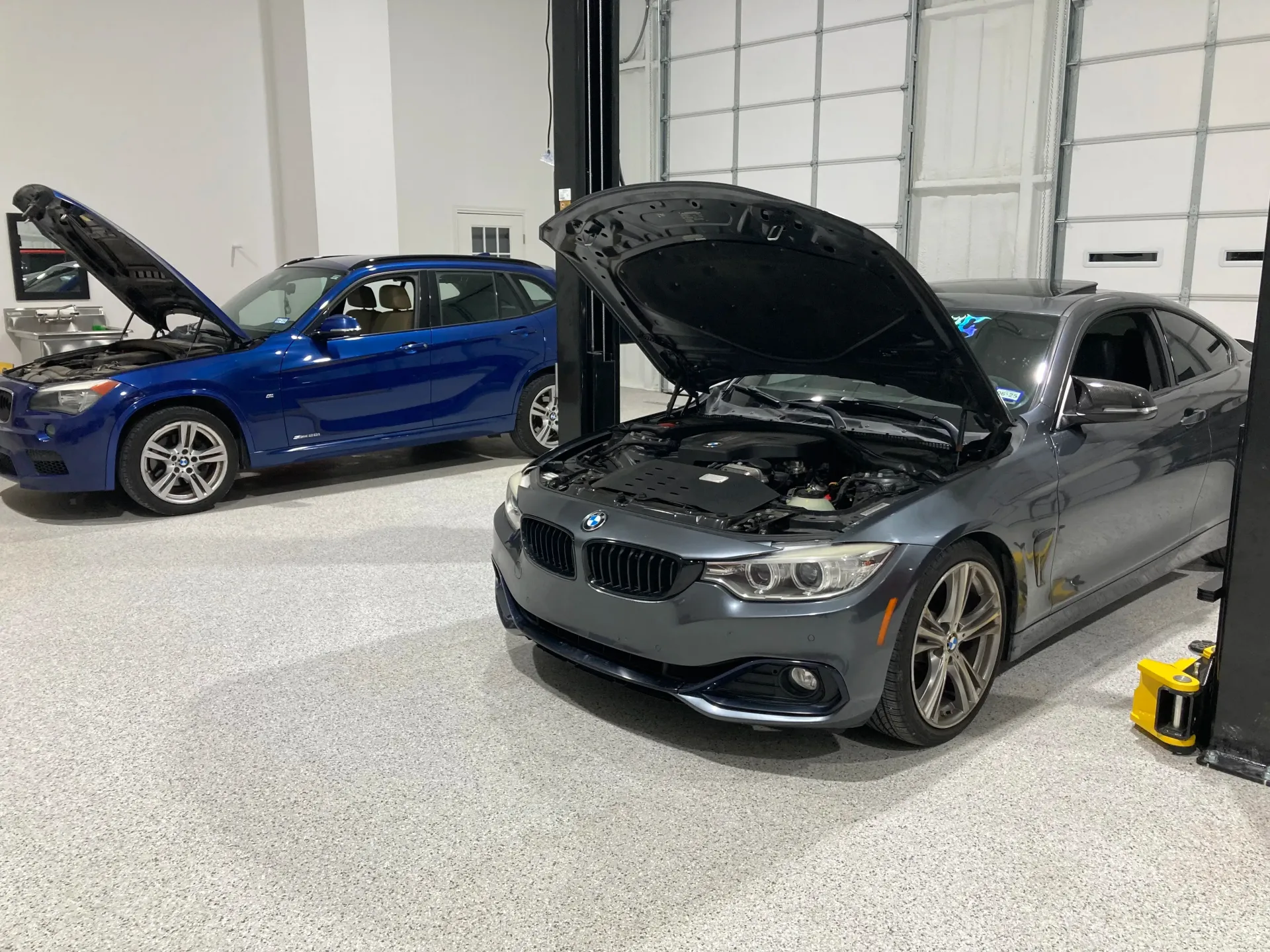 Two Cars with Open Hoods in a Garage | Dillon Auto Repair