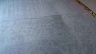 A close up of a white carpet in a room.