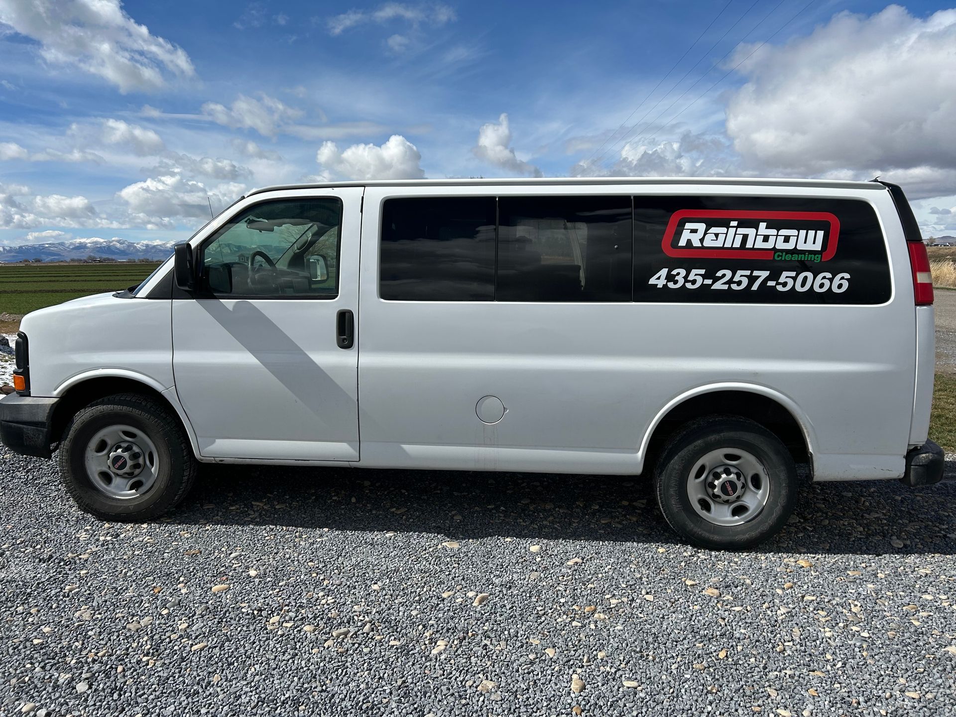 A white van with rainbow cleaning written on the side