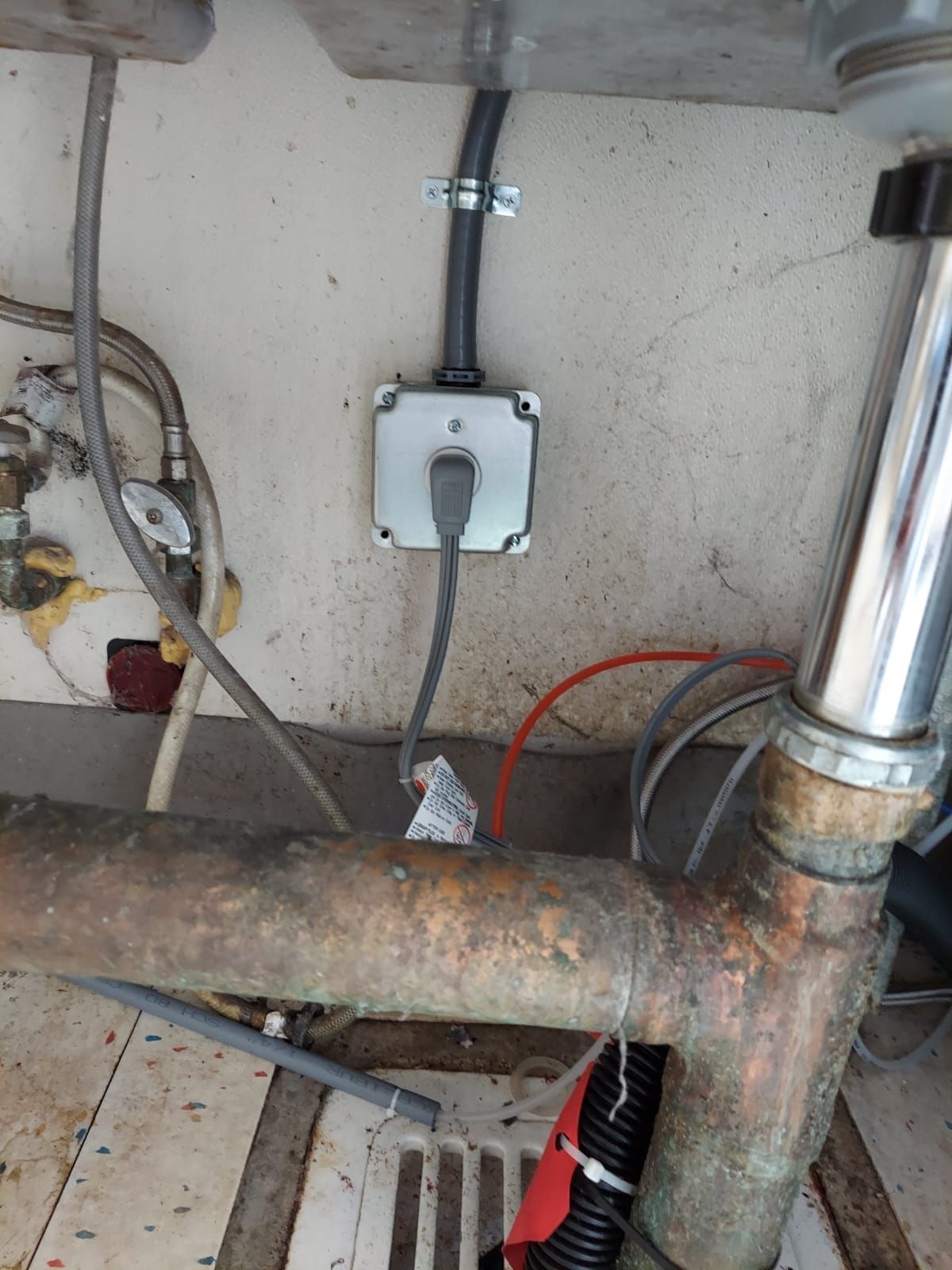 A close up of a sink with a plug plugged into it.