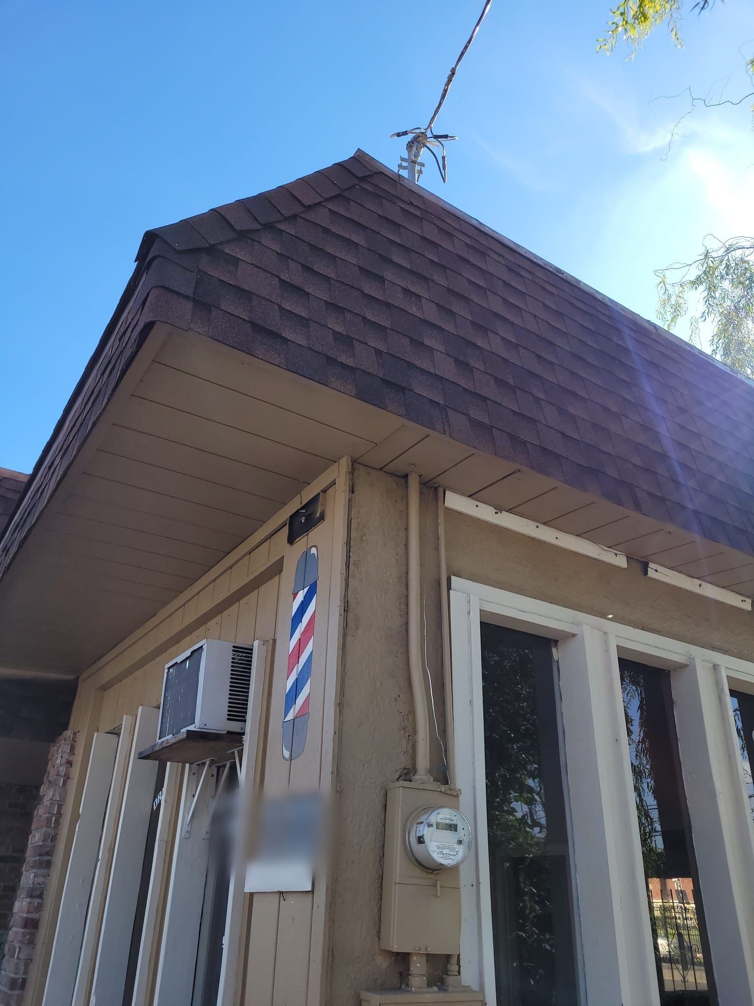 A building with a barber pole on the side of it