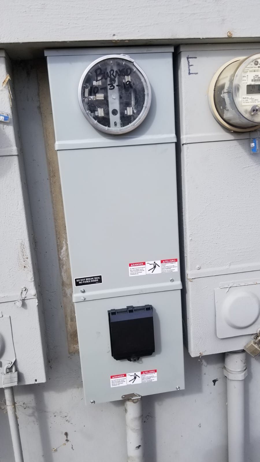 A close up of a electrical box on a wall.