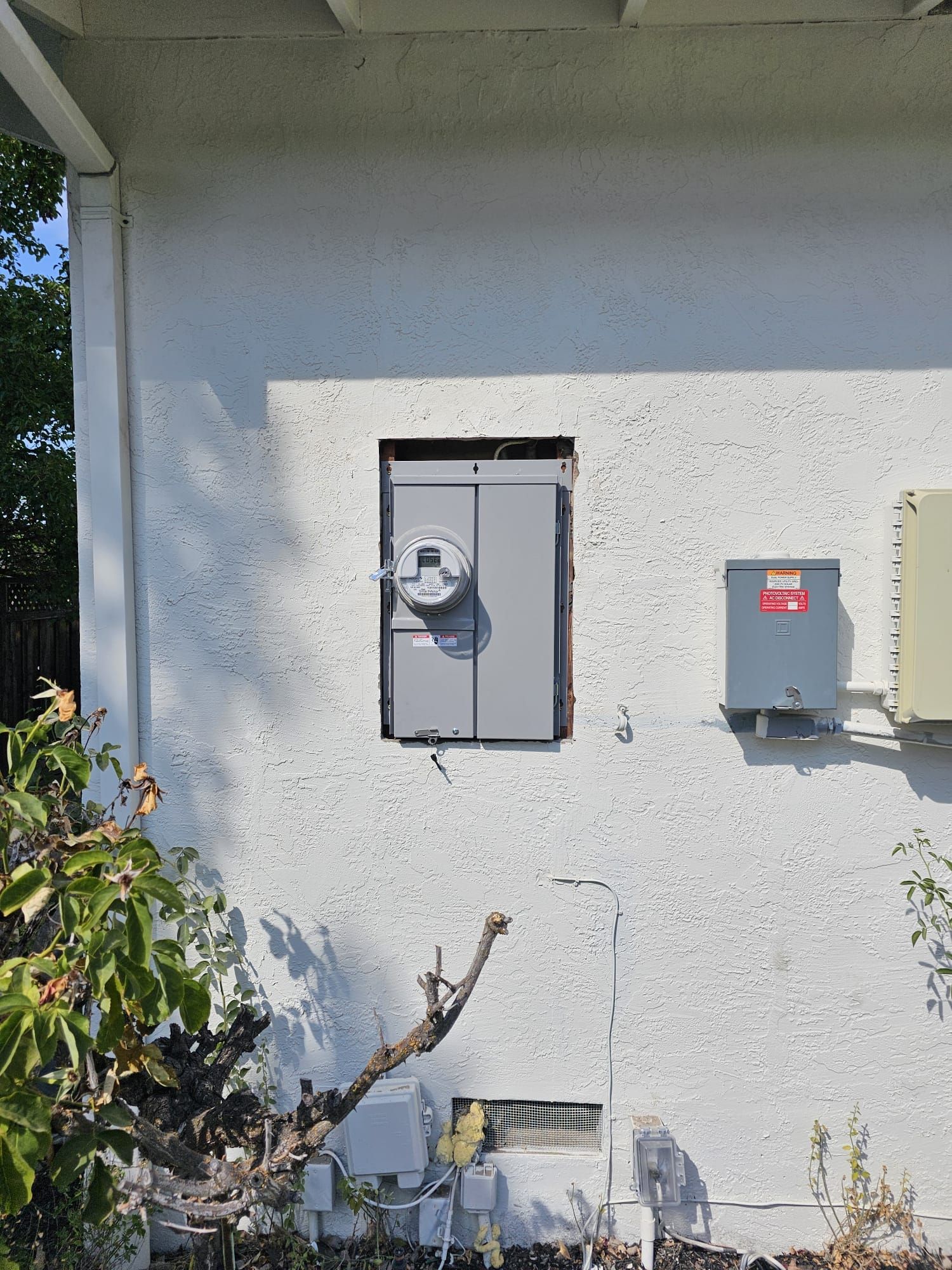 A white wall with a gray box on it.