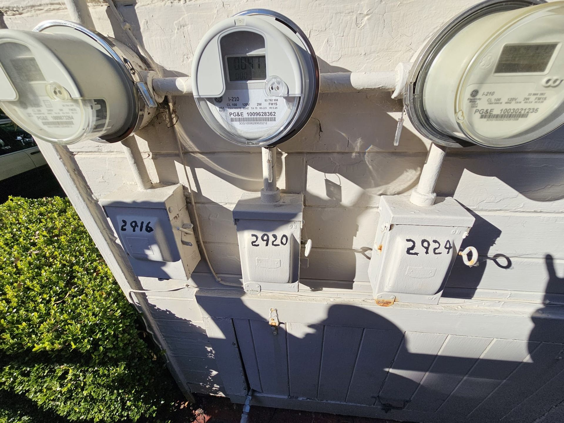 A bunch of electrical meters on a white wall