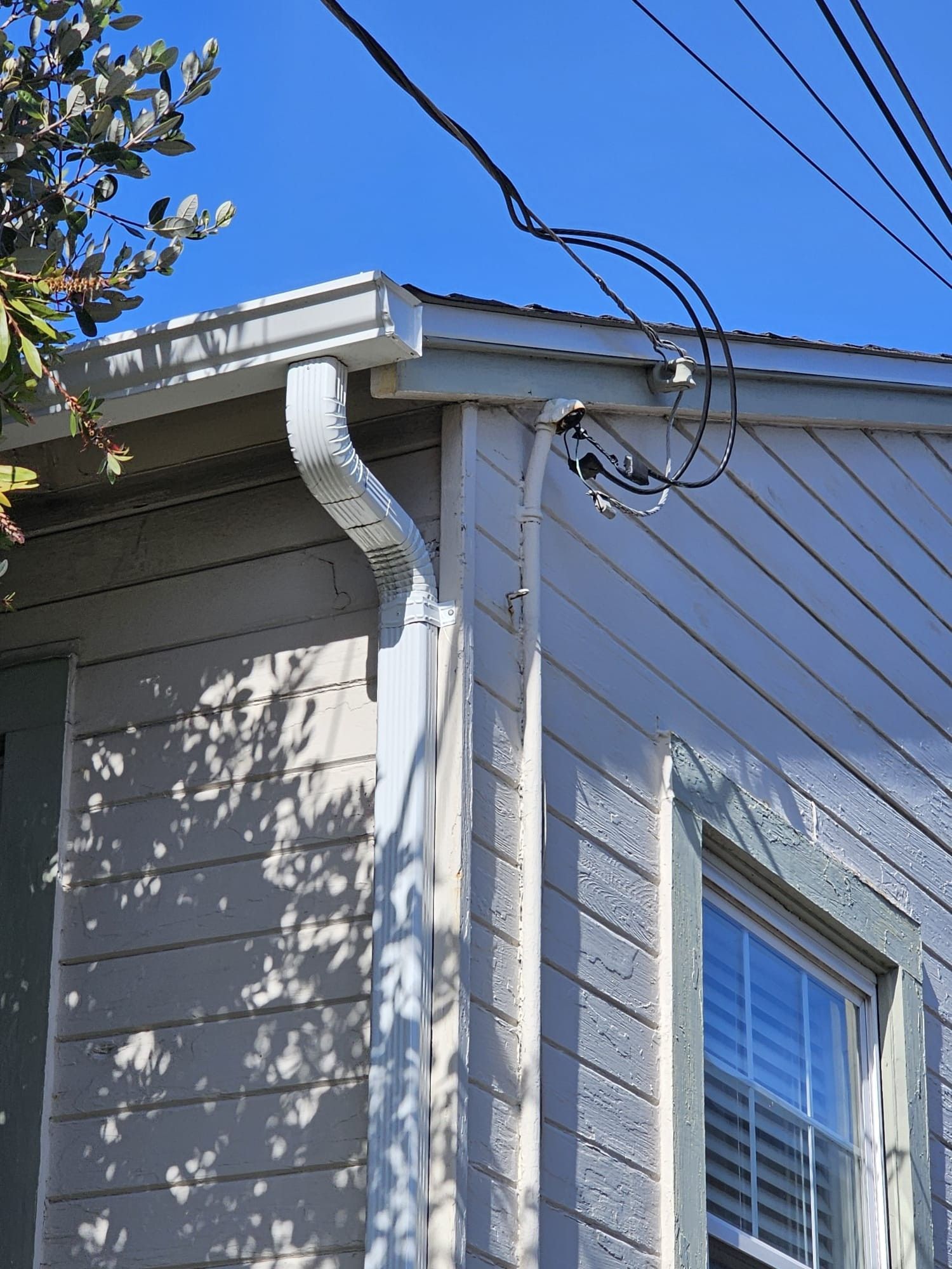 A house with a gutter on the side of it