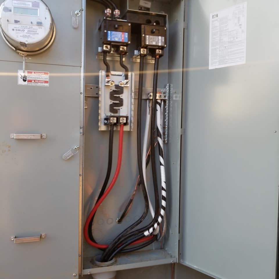 An open electrical box with a meter on top of it