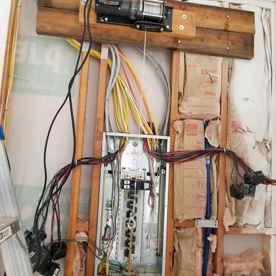 A wall with a bunch of wires hanging from it