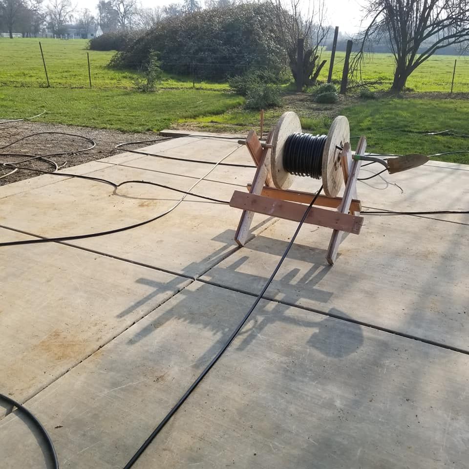 A spool of wire is sitting on a wooden stand