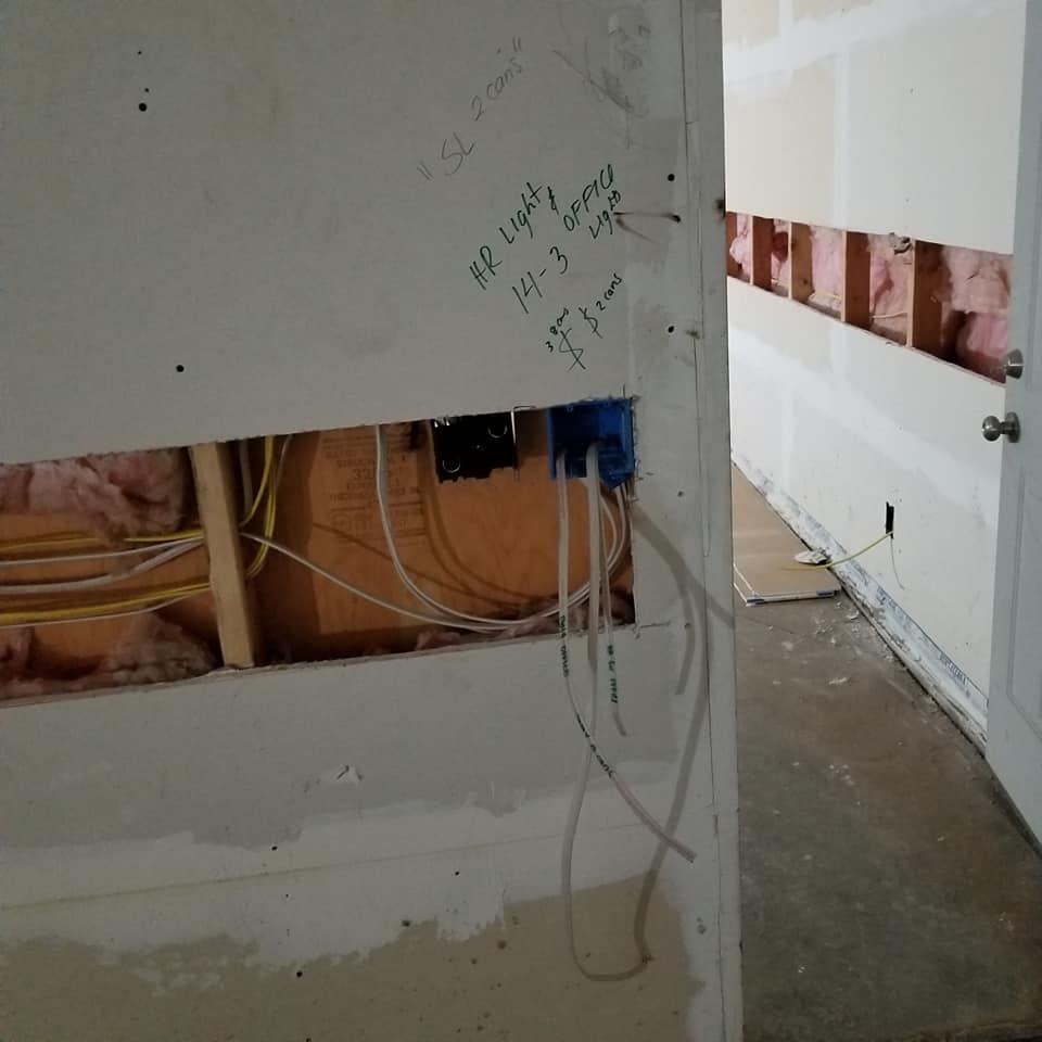 A wall with a hole in it that says