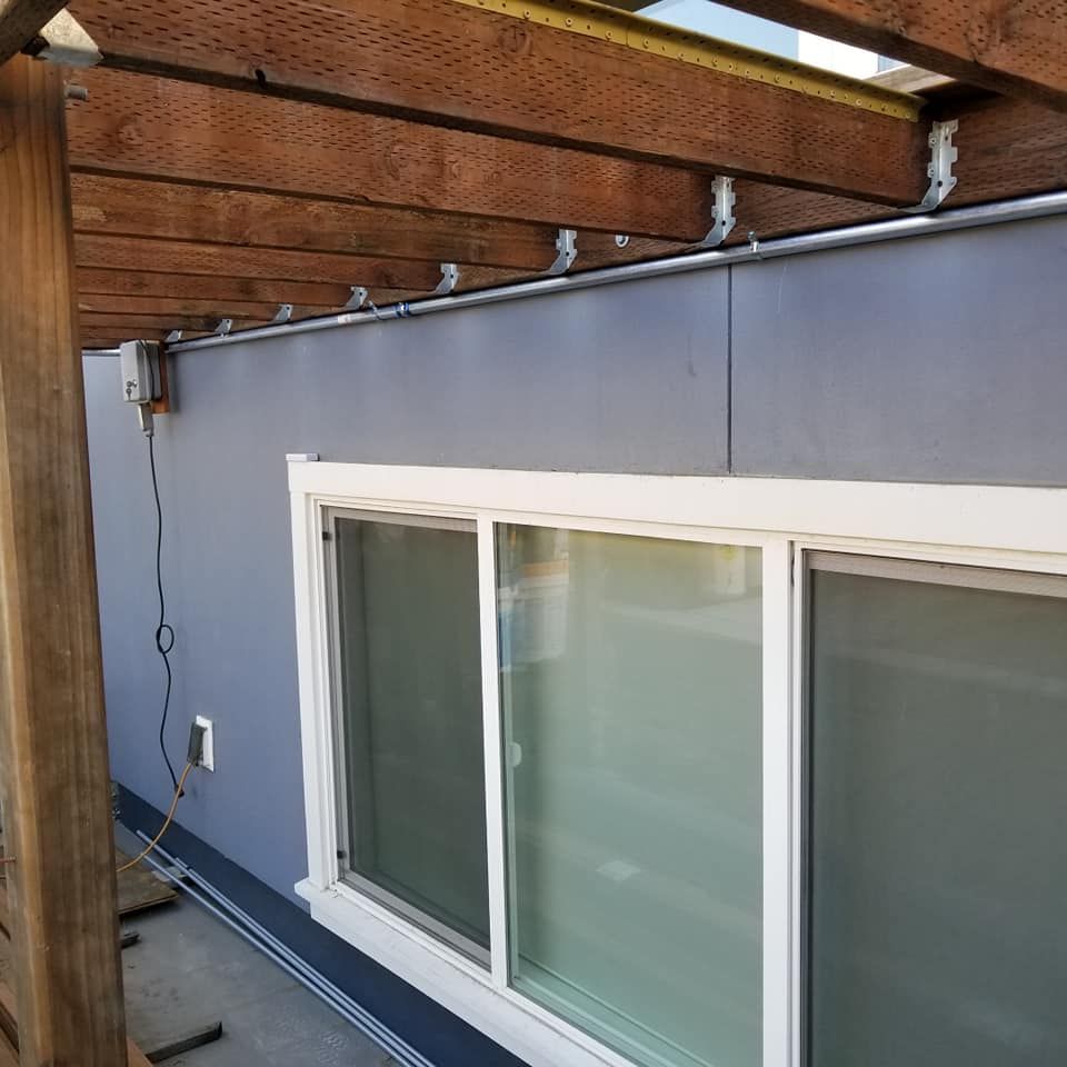 A window with a wooden pergola over it