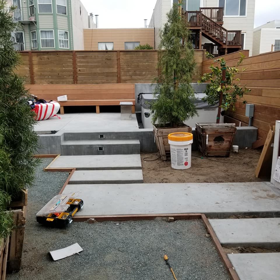A white bucket with a red label that says ' concrete ' on it
