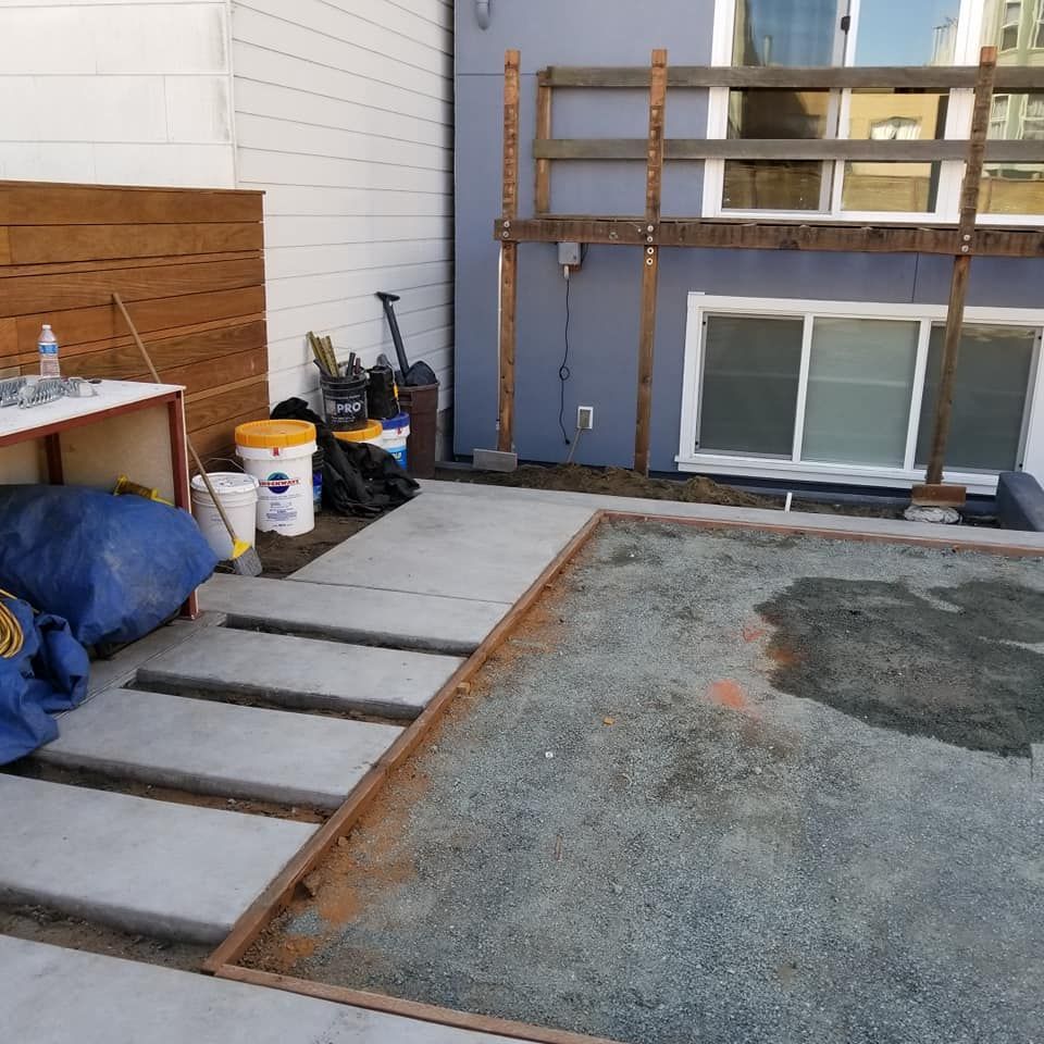 A backyard with buckets and shovels on the ground