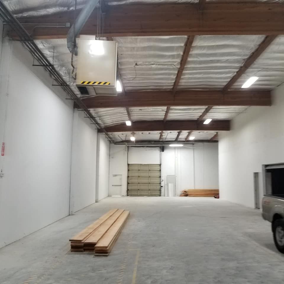 An empty warehouse with a truck parked in it