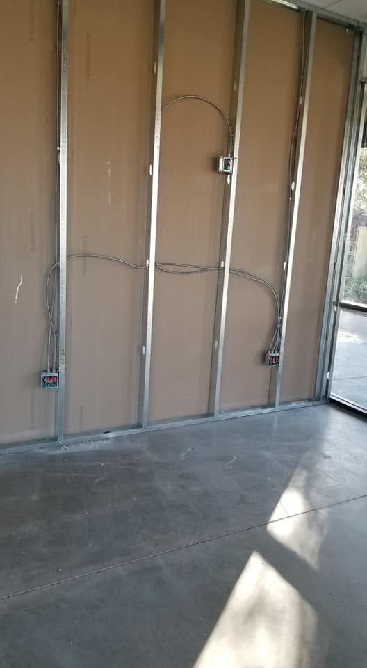 A room with a metal frame on the wall and a concrete floor.