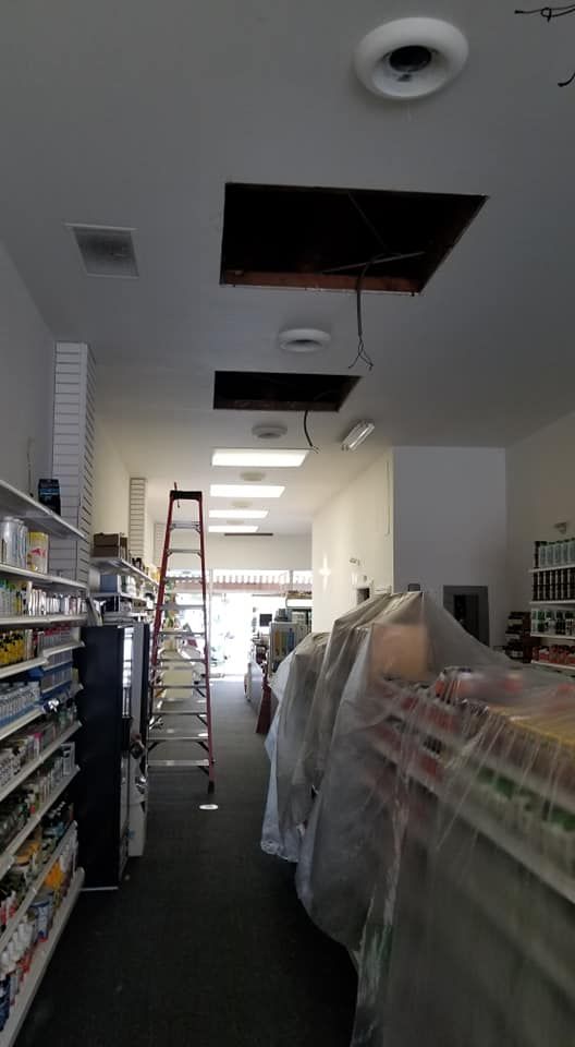 A ladder is hanging from the ceiling of a store.