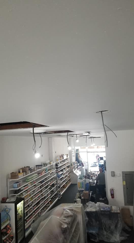 A grocery store with a lot of shelves and a refrigerator.