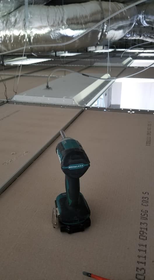 A makita cordless drill is sitting on top of a piece of cardboard.