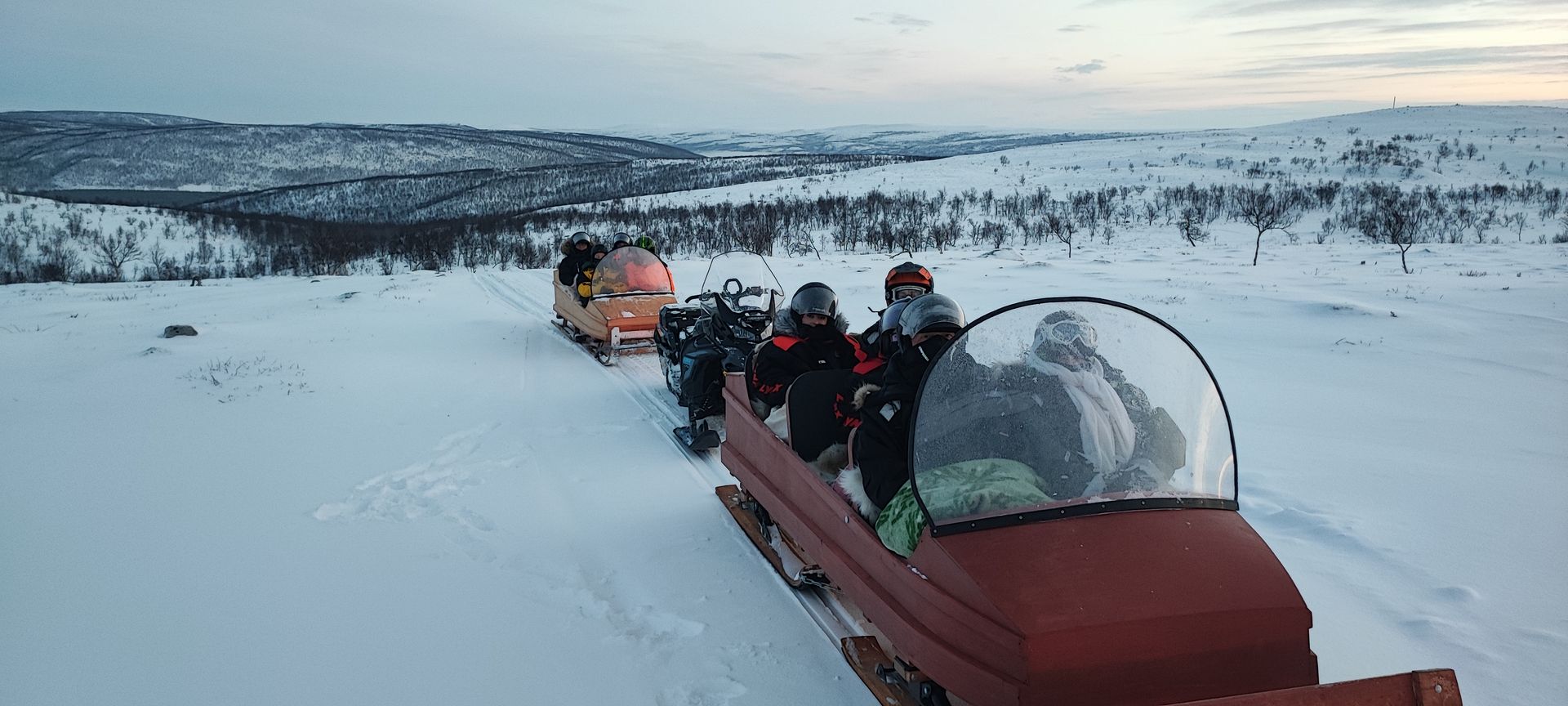 Wooden sleds pulled by guide´s snowmobile. Sleds made by Tenon Vene/ Jouni Laiti.