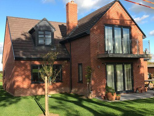 large two-storey house made of brick with large windows