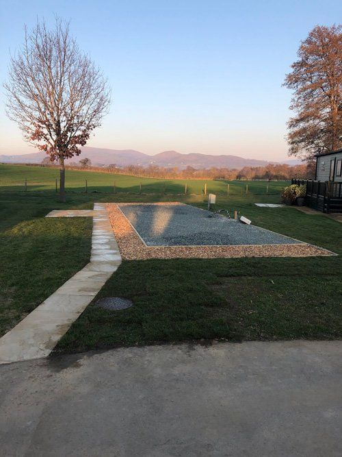 manicured lawn with gravel in middle of garden