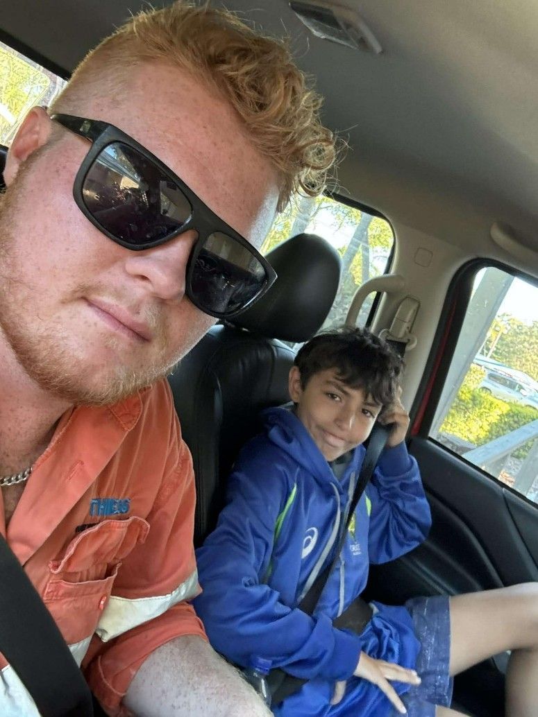 A Man and a Boy Are Sitting in the Back Seat of a Car — Specialist Support Solutions in Rockhampton City, QLD