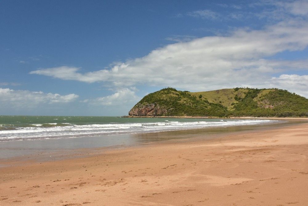 A Beach With a Small Island in the Distance — Specialist Support Solutions in Yeppoon, QLD