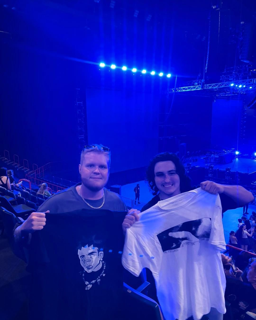 Two Men Are Standing Next to Each Other in a Stadium — Specialist Support Solutions in Yeppoon, QLD