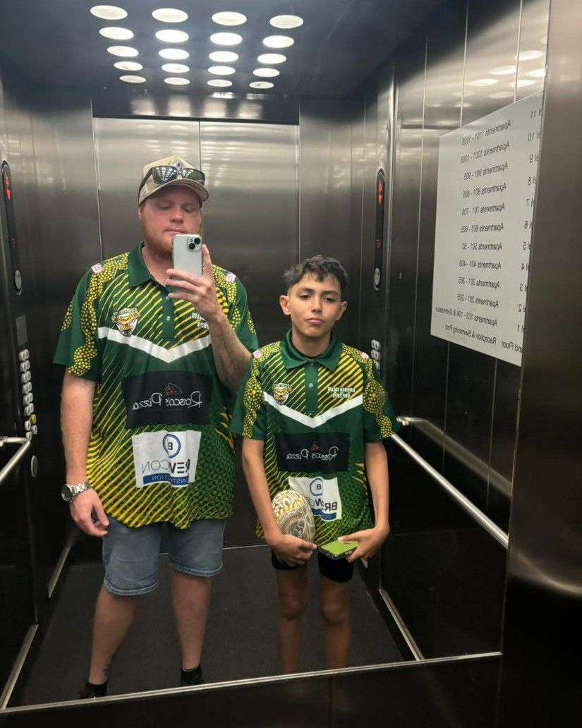 A Man and a Boy Are Taking a Selfie in an Elevator — Specialist Support Solutions in Yeppoon, QLD
